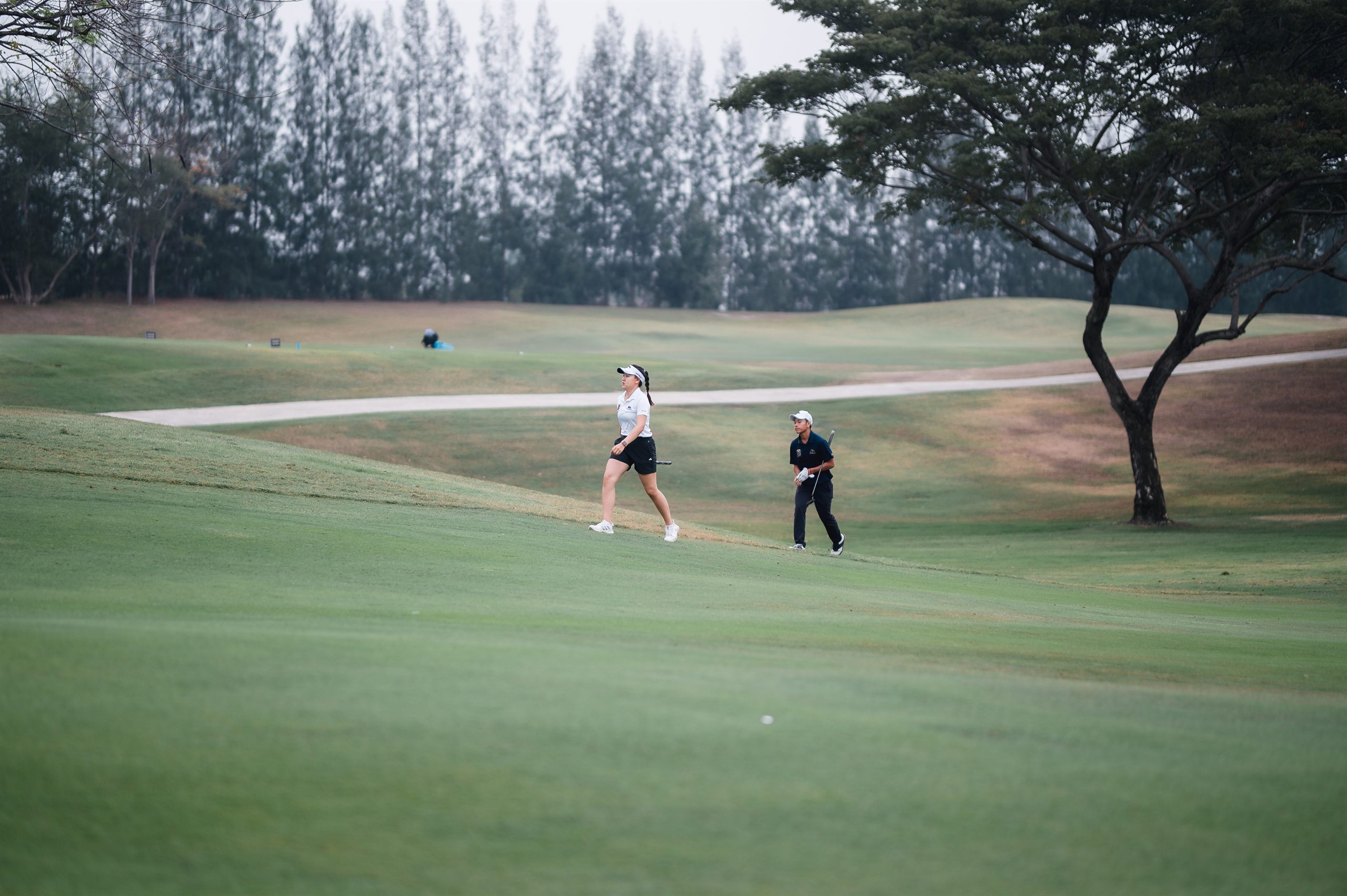 JAGA student-athletes walking the fairway